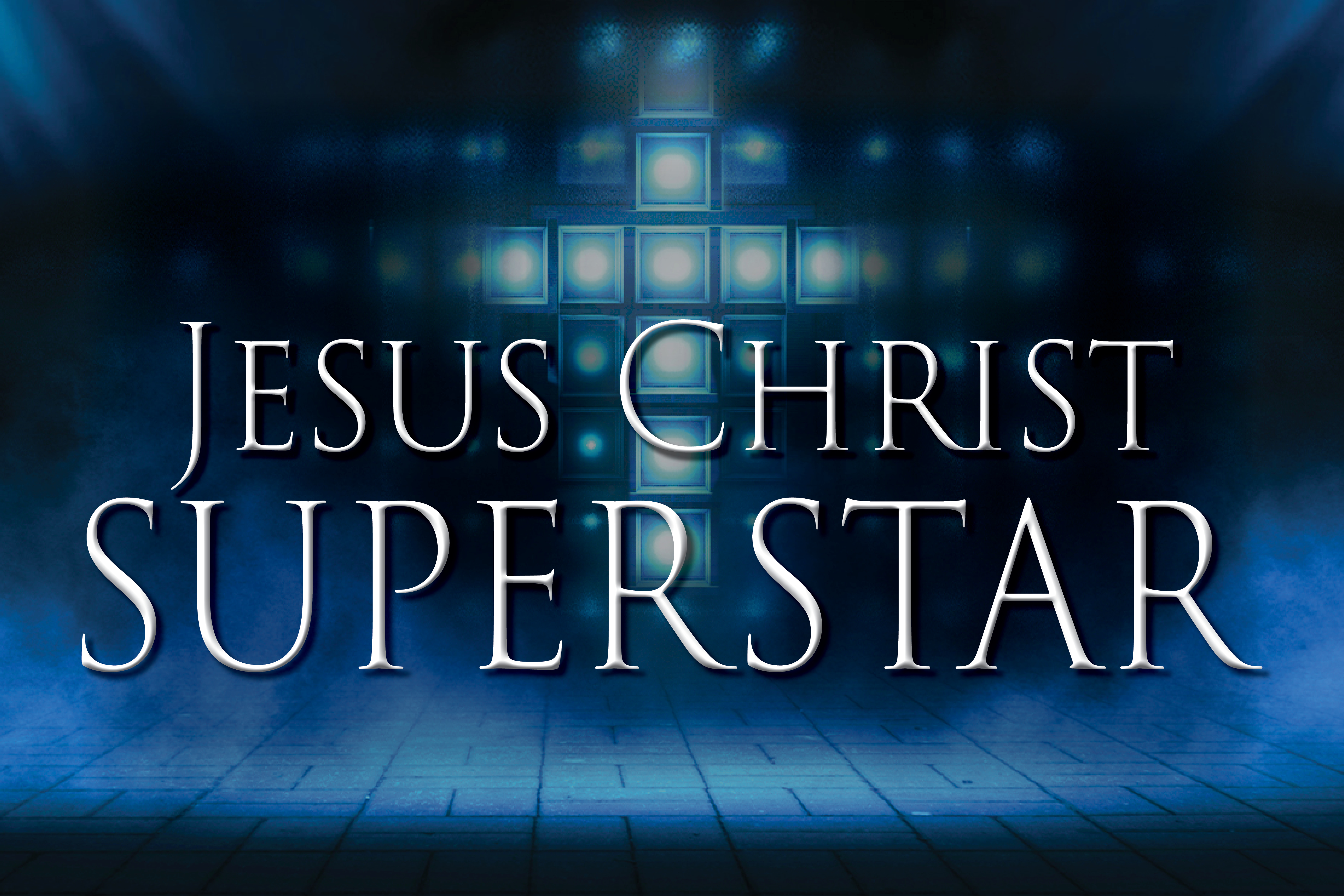 This promotional image for Jesus Christ Superstar features the title in bold, white letters against a sparkling, bokeh background. The backdrop transitions from warm golden hues at the top to cool blues at the bottom, with light sparkles 